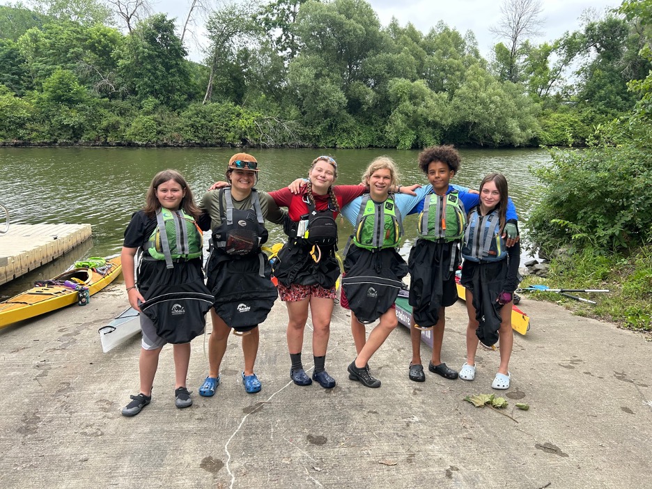 The group of six on this year's Champlain Discovery Kayak Expedition stand ready to set off on their trip on Lake Champlain.