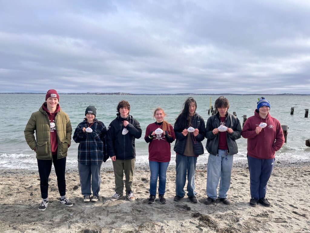 The Mount Abraham Union High School youth rowing team proudly displaying their championship Clam shells after rowing the “Frank Beckett” to victory.