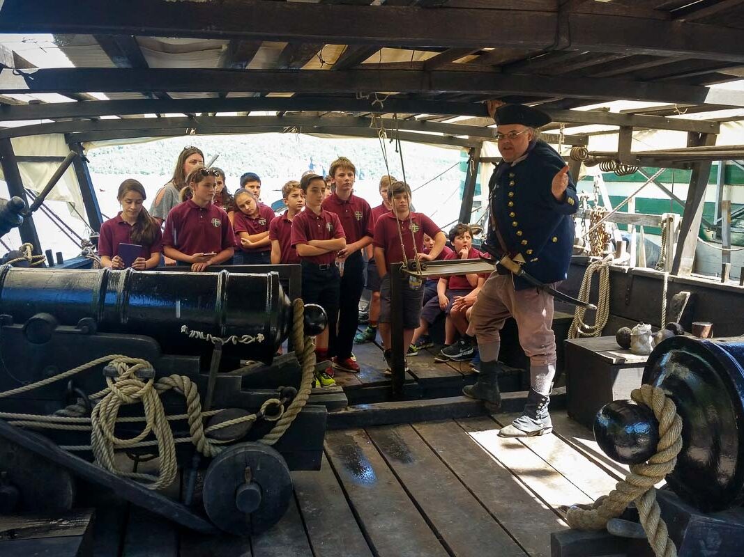 Image of school kids aboard the Philadelphia 2 with an historic 1776 era interpreter